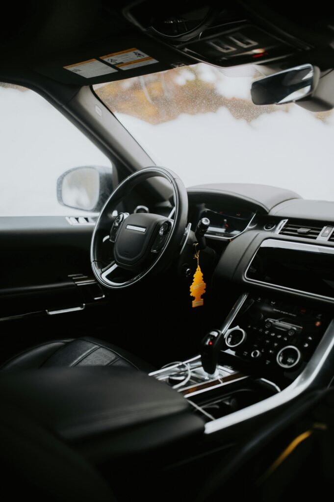 Elegant interior of a luxury car featuring a sleek modern dashboard and steering wheel.