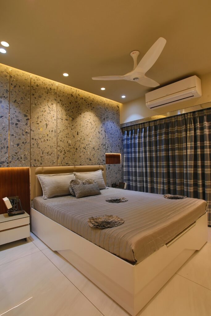 Contemporary bedroom design featuring an AC unit, stylish bedding, and elegant lighting.