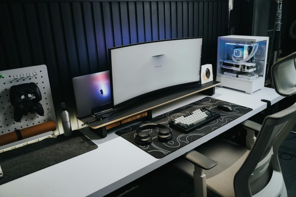 A sleek, modern office setup with a gaming PC, curved monitor, and accessories, ideal for tech enthusiasts.
